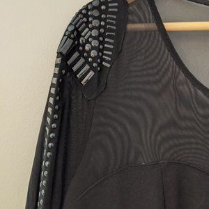 Little black dress with mesh, studded sleeve